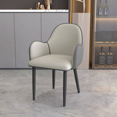 Its rounded high back and low integrated arms create a cocoon-like feel, ideal for both kitchen chairs and formal dining rooms.