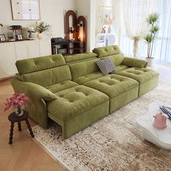 Green sectional sofa in a living room with decor elements.