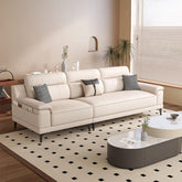 Modern living room with a white sofa, coffee table, and large windows.