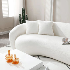 Curved kidney-shaped sofa with plush cushions, fabric sofa, stylish sofa design