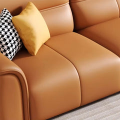 Upholstered in durable leatherette, its modern silhouette features a low back, rounded arms with piping, and segmented stitching for lumbar support.