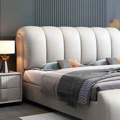 Side view of Hugo bedcot, new bed design + bed frame – plush curves and soft upholstery