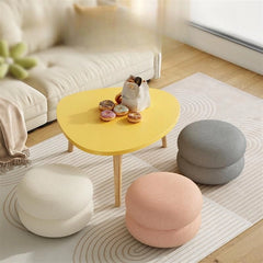 Upholstered in tactile boucle fabric in shades like grey, pink, cream, this pouffe chair adds texture and calm to your decor.