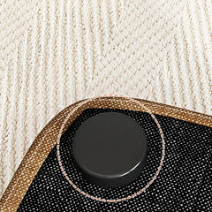 Close-up of a textured phone case with a black pop socket on a beige fabric background