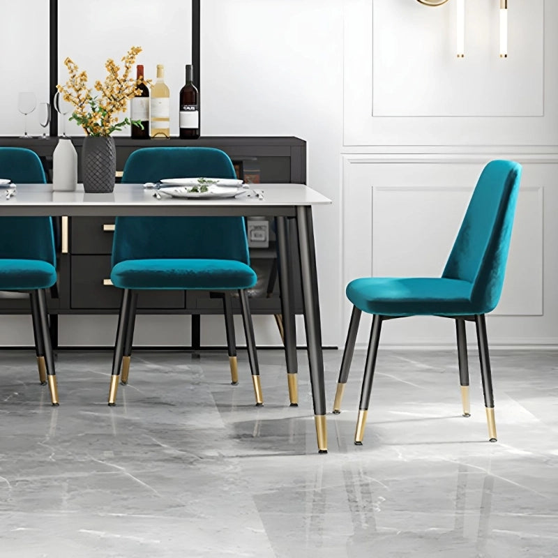 The black tapered metal legs with gold tips add sophistication, perfect for pairing with a contemporary dining table.