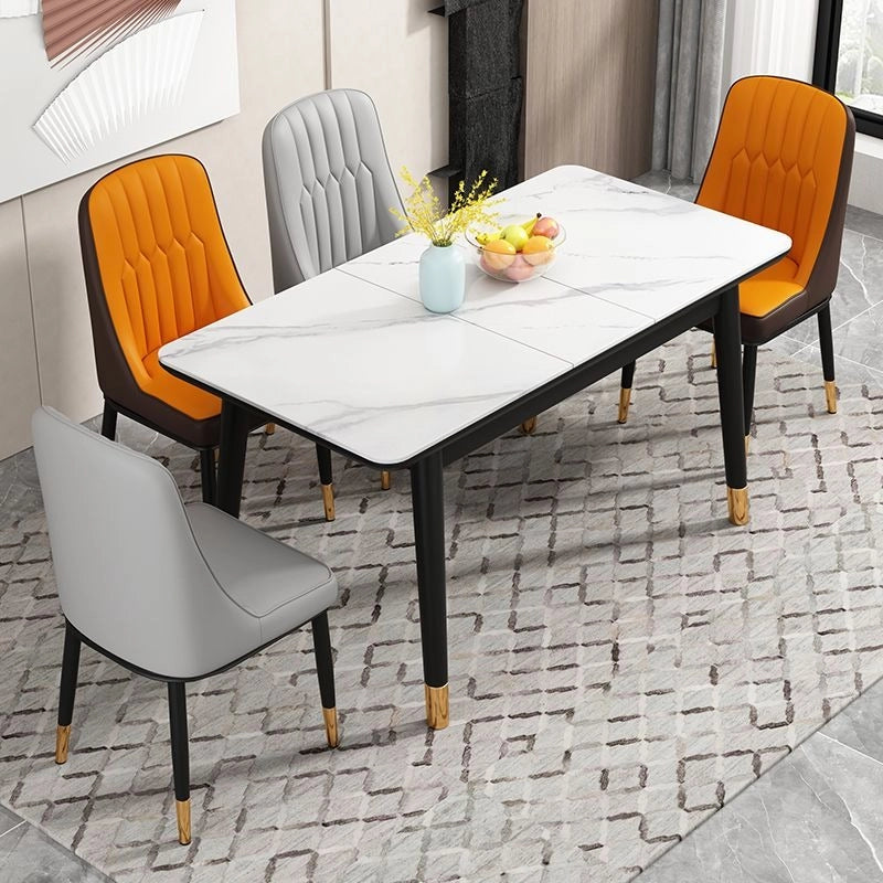 The combination of orange seat and brown shell adds vibrancy, while the slim black metal legs with gold-dipped ends offer contemporary flair. 