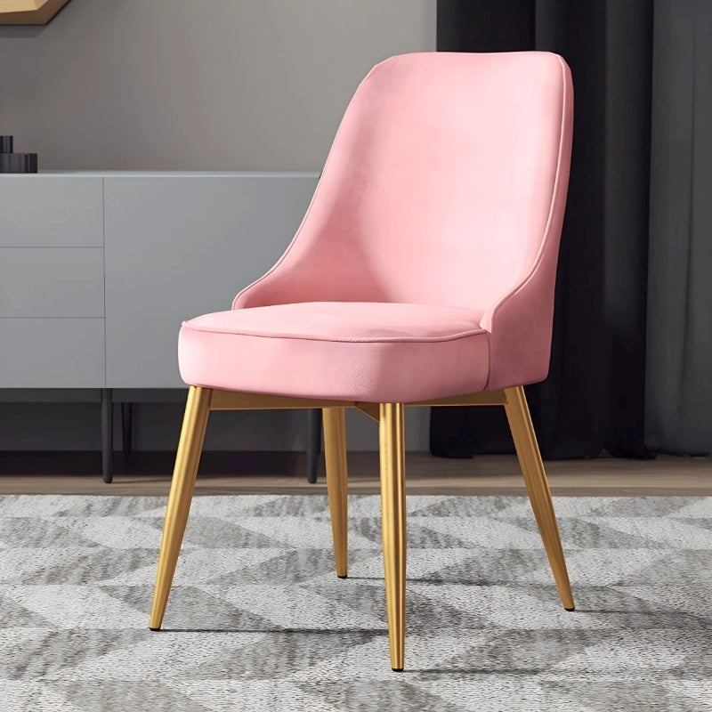 Bring home elevated elegance with this velvet upholstered dining chair, featuring a curved parsons back, plush waterfall seat, and chic tapered gold metal legs