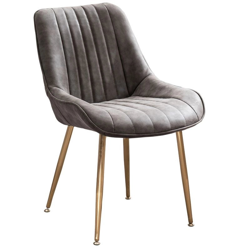 Designed with luxurious vertical channel stitching, plush cushioning, and glamorous gold tapered legs, these dining chairs add a touch of modern elegance to any setting. 