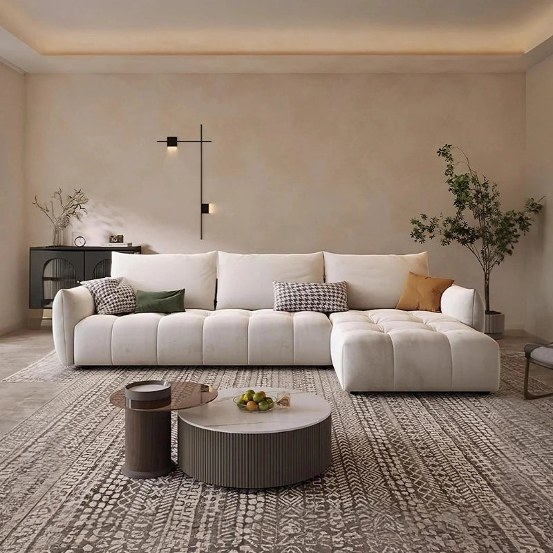 This elegantly designed settee blends soft curves with oversized cushions to create a relaxed, sculptural profile