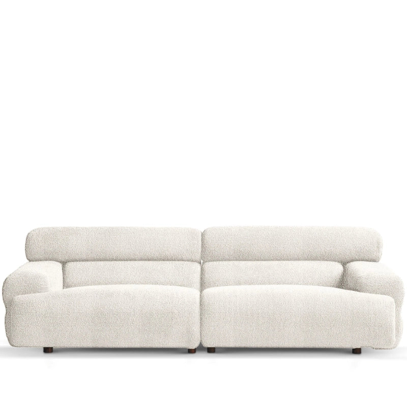 Upholstered in a plush boucle fabric, it brings both tactile warmth and stylish form to modern interiors.