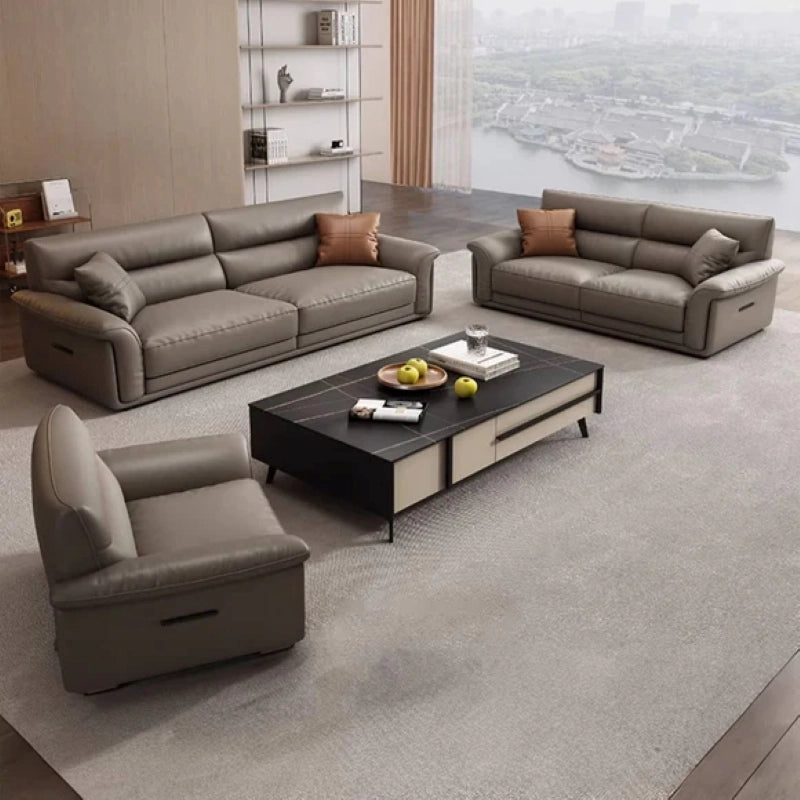 Upholstered in matte taupe leather, it combines the comfort of pillow-top armrests with the durability of a reinforced Neem wood frame. 
