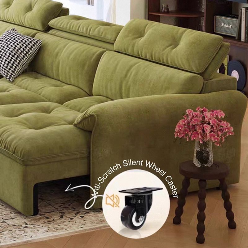 Green sectional sofa with a small table and flowers in a room setting, highlighting anti-scratch silent wheel casters.