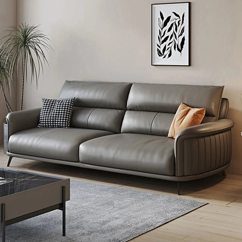 The sleek flared arms and stitched details lend it a settee-like elegance, while matte black metal legs give the piece an airy silhouette.
