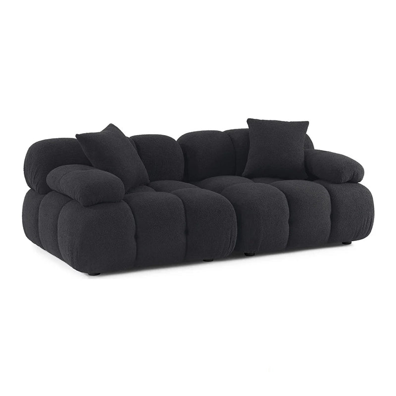 Black sofa with cushioned design on a white background