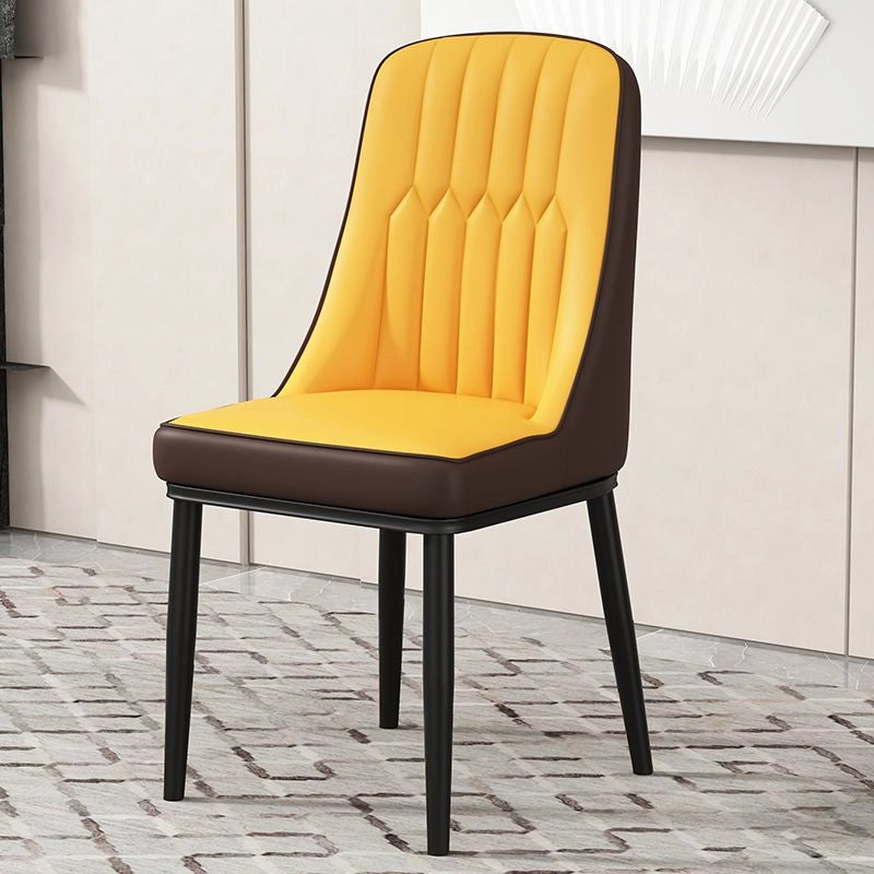 Crafted with soft leatherette upholstery, vertical channel tufting, and sleek tapered legs with gold tips, this dining chair adds style without compromising comfort.