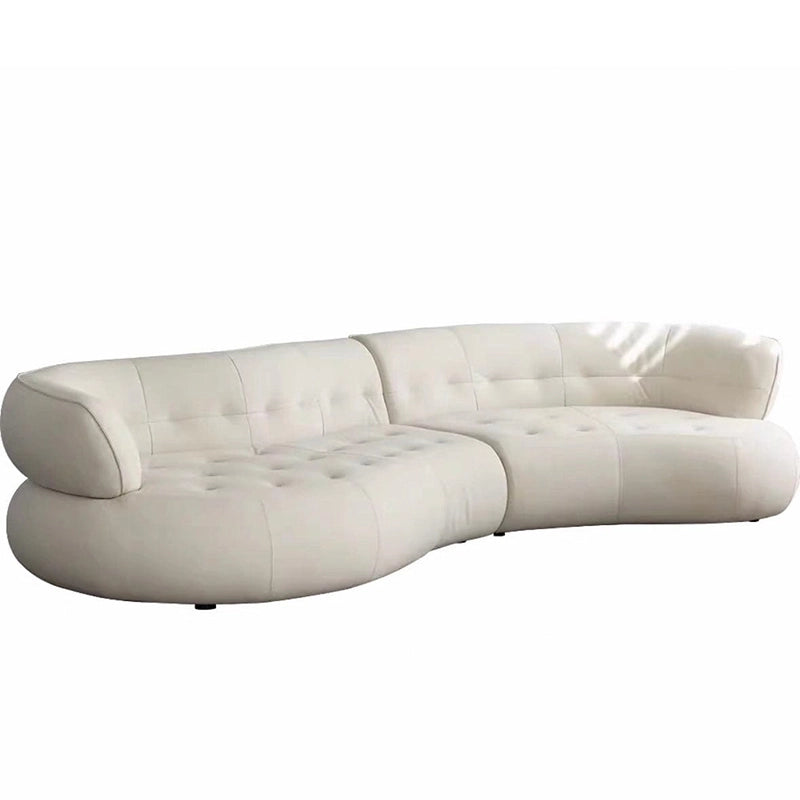 With its boomerang-style layout and crescent-shaped form, it balances organic modern design with deep ergonomic comfort.