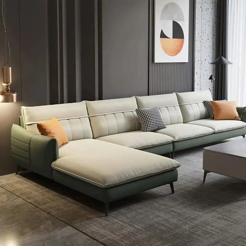 Modern sectional sofa in a living room with decorative pillows and a abstract art piece on the wall.