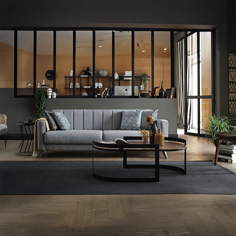 Its linear 3+2+1 layout, wrapped in plush grey velvet-like fabric, showcases a Scandinavian-modern ethos