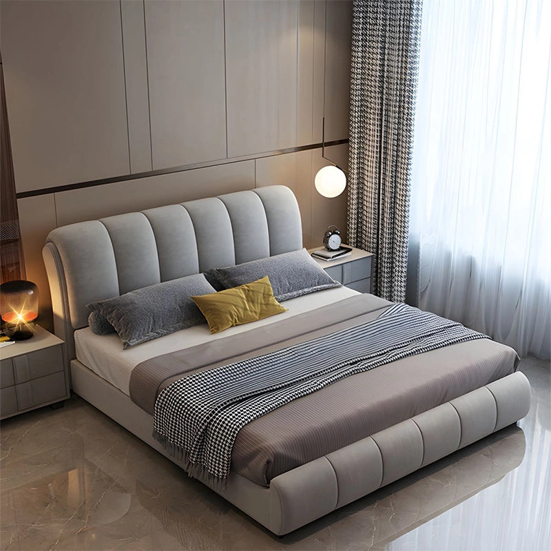 Upholstered in premium fabric, the bed includes a curved channeled headboard and footboard that exude soft modernity.