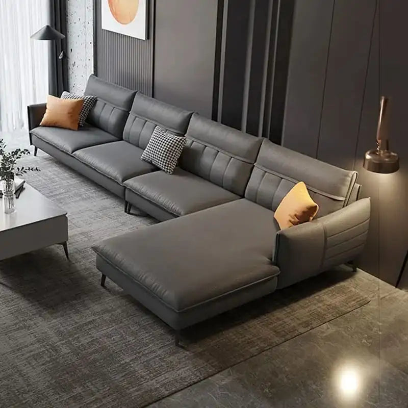 Gray sectional sofa in a modern living room setting with decorative pillows.