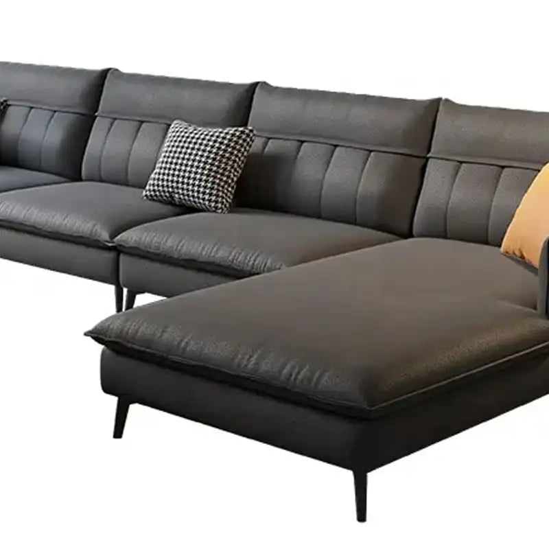 Gray sectional sofa with cushions on a white background