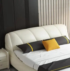 Low-profile tan bed with chrome legs featuring bed and cot styling and bed frame silhouette