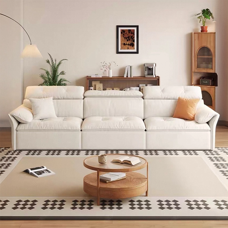 White sectional sofa in a living room with a coffee table and decorative items.