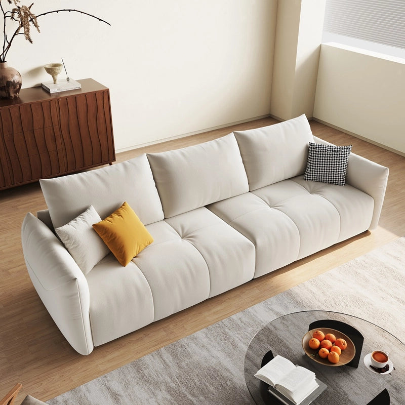 Its low-profile shape with hidden legs and channel tufting aligns with current contemporary and modern sofa design preferences