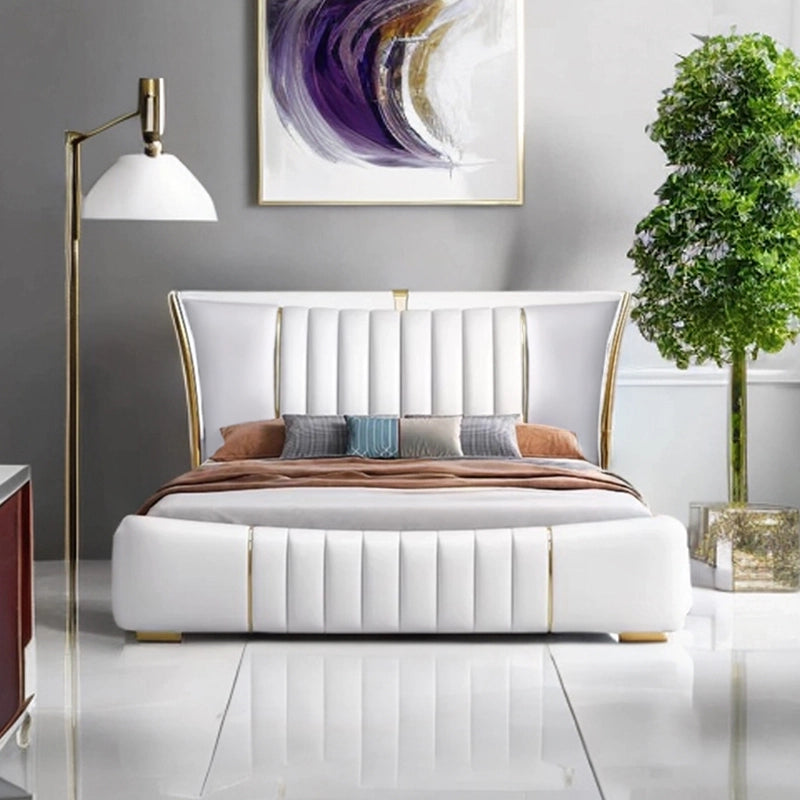 The low-ground structure rests on gold-capped legs and includes a padded footboard with consistent tufting.
