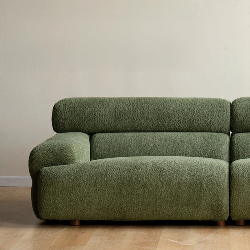 This Scandinavian-modern settee in moss green pairs bold volume with soft textures.