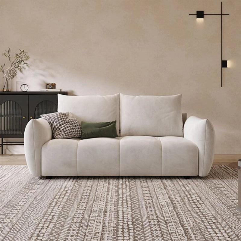  Crafted in soft ivory cloth fabric, the design includes pillow-style high backs, deep seating, and curved arms for ergonomic comfort.