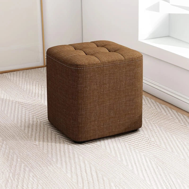 Brown ottoman on a light gray carpet
