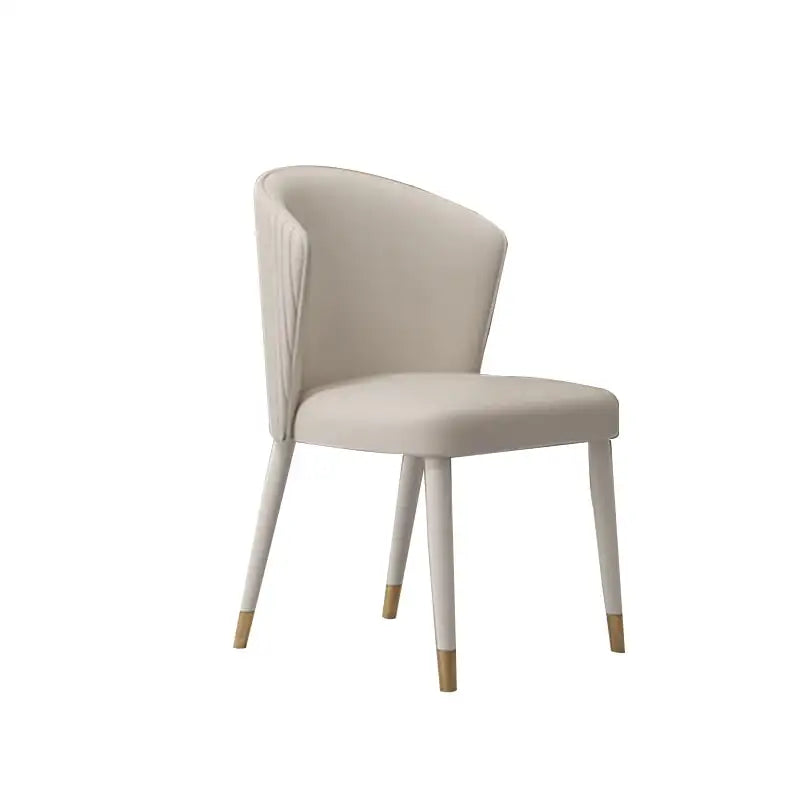 Tapered legs painted in black or white end in luxe gold metal caps that echo Art Deco influences.