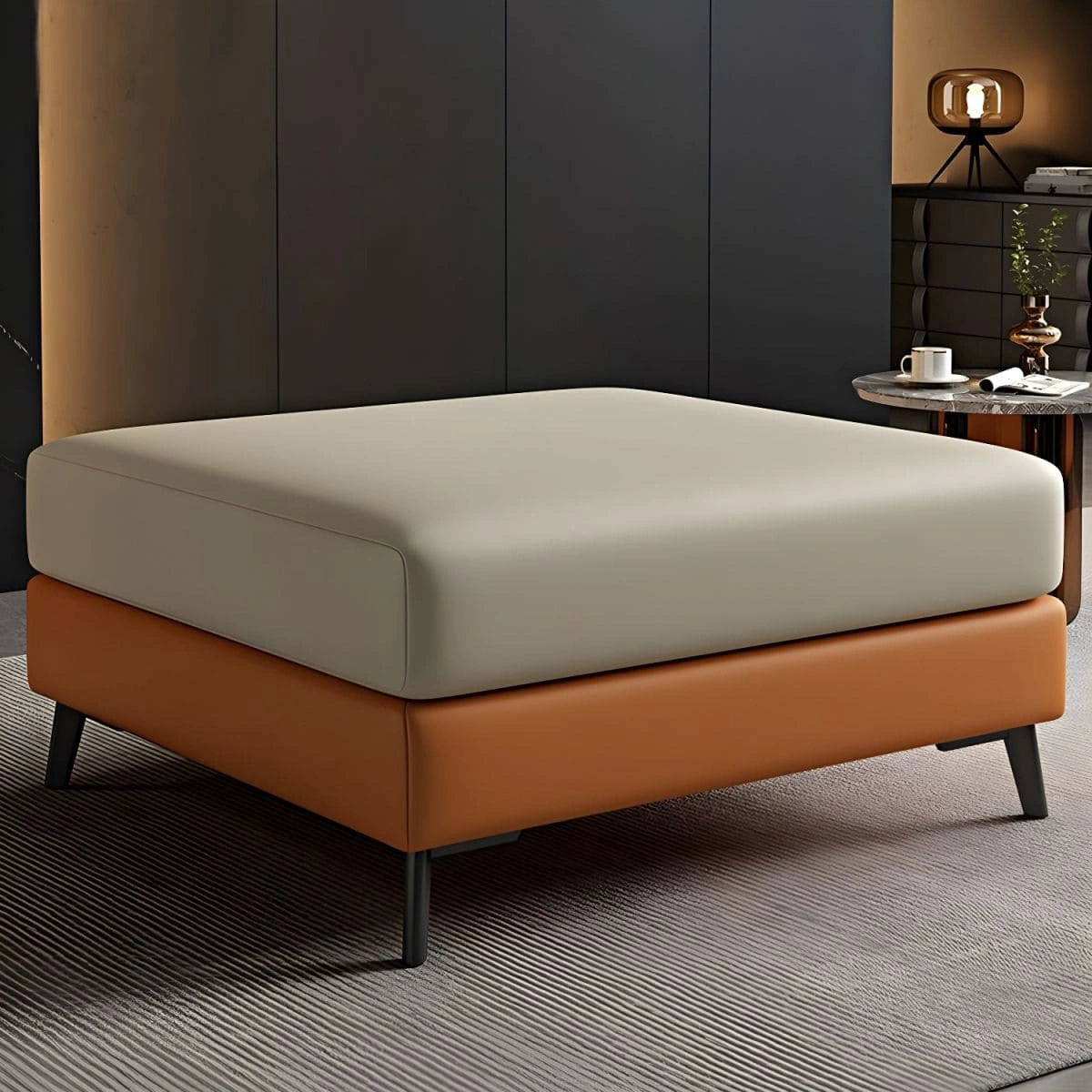 The Dune ottoman is a modern square footstool crafted for refined living spaces.