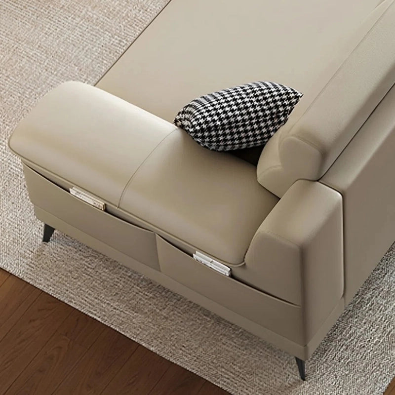 Tapered black metal legs lift the design, while panel tufted cushions add refinement