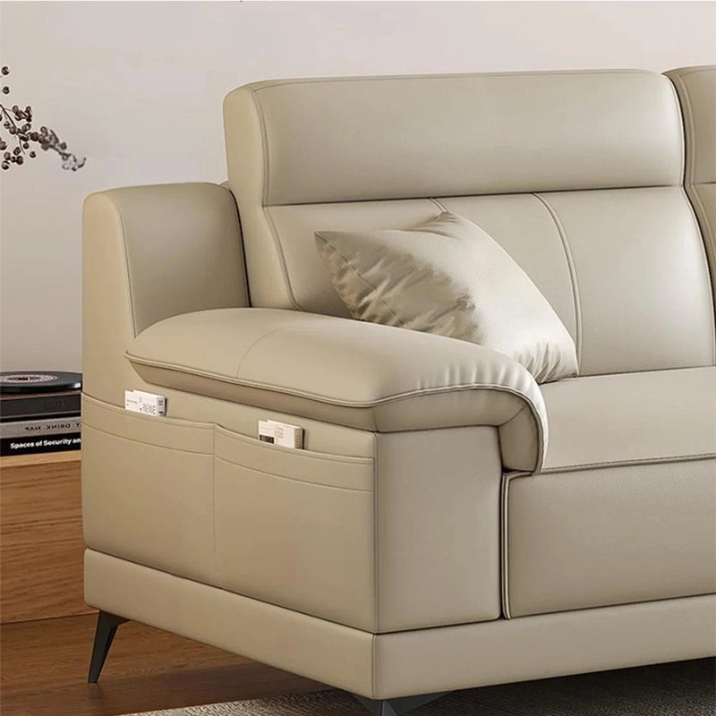 Beige leather sofa with a pillow in a room setting